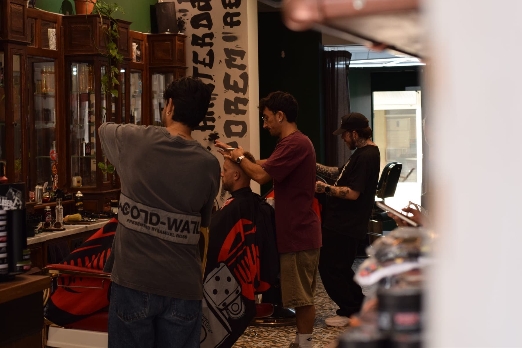 Three barbers working the shop floor at Porem Barbershop Amsterdam