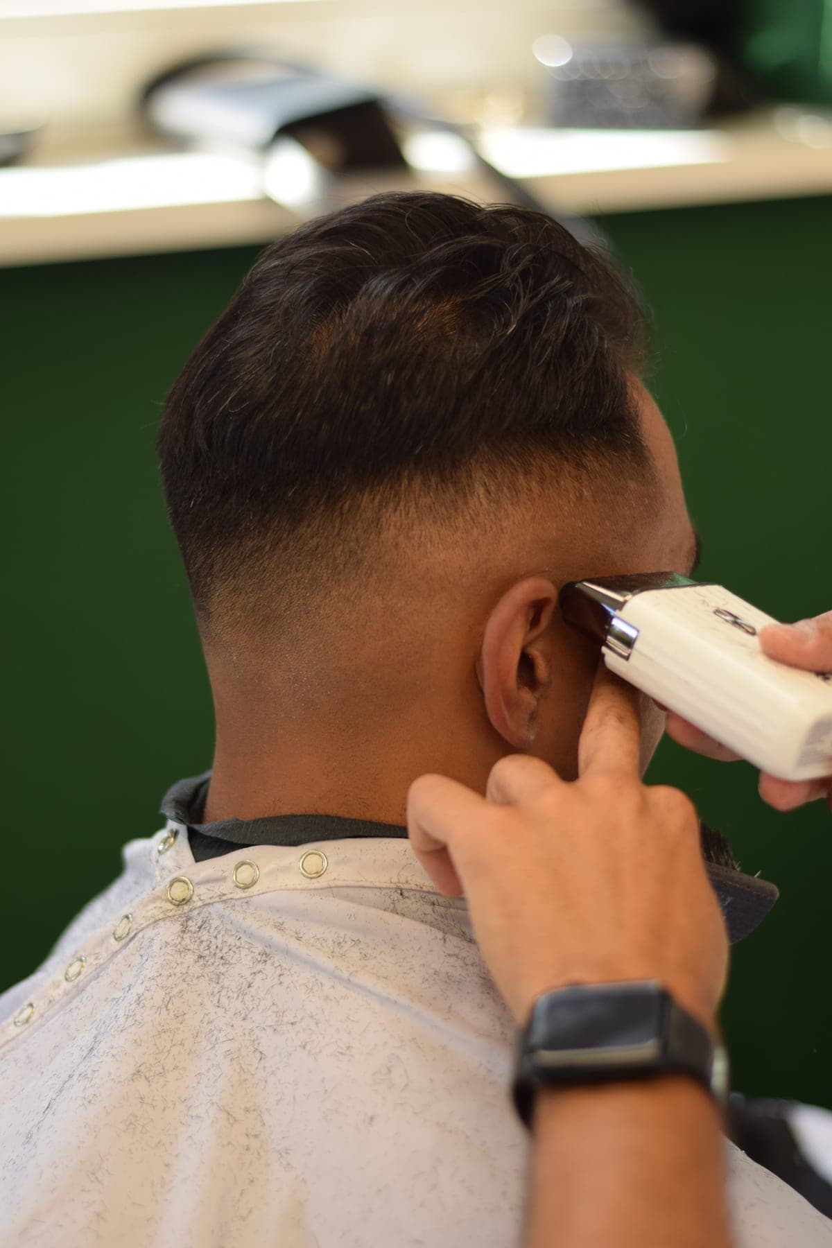 Close-up of a skin fade being lined up with a trimmer at Porem Barbershop Amsterdam
